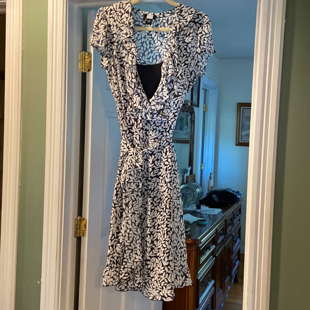 This is a cute flirty dress has side zip and a full black slip dress underneath.